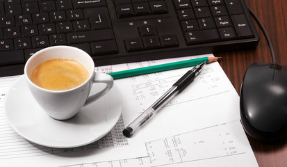Keyboard, mouse, papers, pen,  pencil and cup of coffee on the table