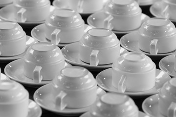 Sets of clean white cups and saucers - black and white