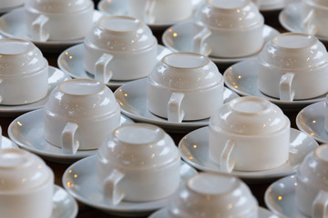 Sets of clean white cups and saucers