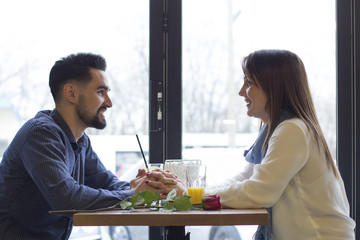 Young couple in cafe on date