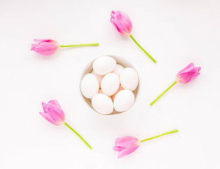Easter composition. Spring purple flowers and easter eggs on white background. Flat lay.