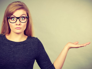 Nerdy woman in eyeglasses being confused