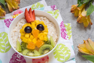 Oatmeal porridge with a chick face decoration