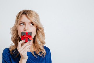 Amazing young woman holding gift