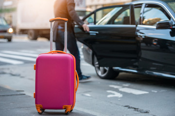 People taking taxi from an airport and loading carry-on luggage bag to the car. Luggage on the city street. Travel concept. - 140254181