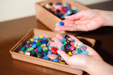 Fototapeta premium colorful sewing buttons in the hands