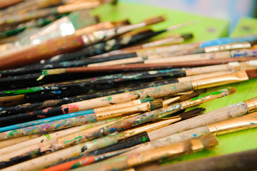Fototapeta premium used paint palette, watercolors, brush - art lesson