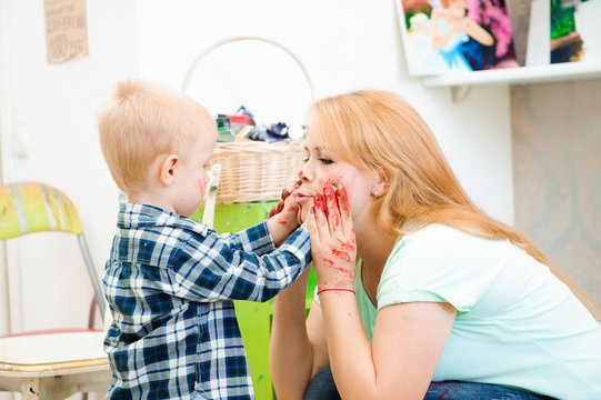 Mother and child draw a picture paints, art lesson