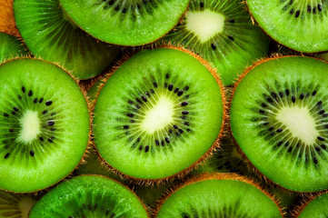 Juicy green round pieces of kiwi on the surface