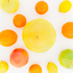 Fruit's background. Citrus fruits pattern made of lemon, orange, grapefruit, sweetie and pomelo on white background. Flat lay, top view.