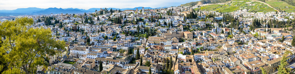Fototapeta na wymiar Panoramic landscape of Albaicín neighborhood in Granada. Typical Spanish village with white houses. 