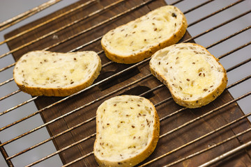 roasted seeds slices of bread on the oven shelf