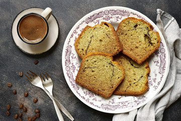 Banana cake with cup of coffee for a breakfast.Top view.