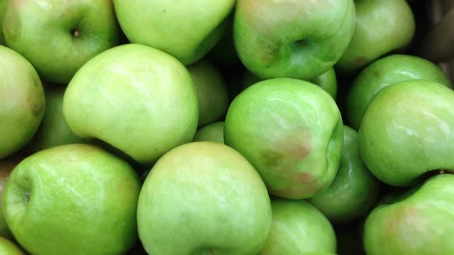 Camera trucks over vibrant green apples