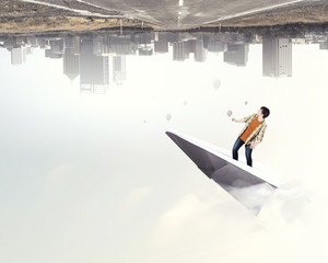 Obraz premium Hipster guy surfing sky . Mixed media