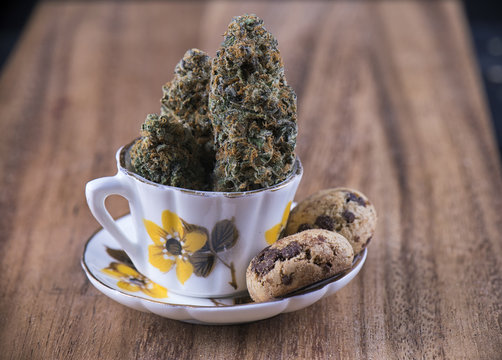 Cannabis nugs and infused chocolate chips cookies - medical marijuana edibles concept