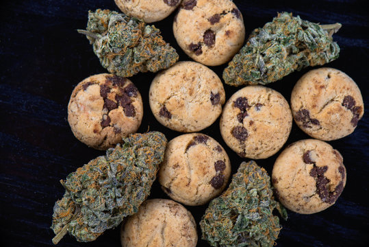 Cannabis nugs and infused chocolate chips cookies - medical marijuana edibles concept