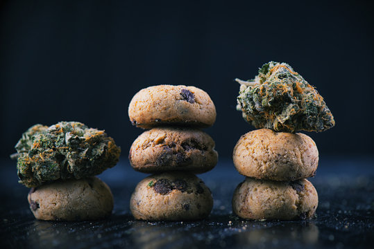 Cannabis nugs over infused chocolate chips cookies - medical marijuana edibles concept