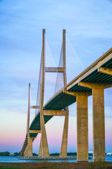 a large suspension bridge spans the distance between two coasts over an ocean inlet