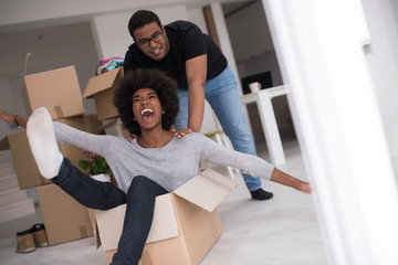 African American couple playing with packing material