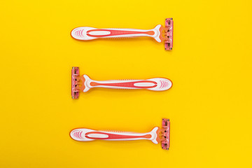 Three razors for women on a yellow background