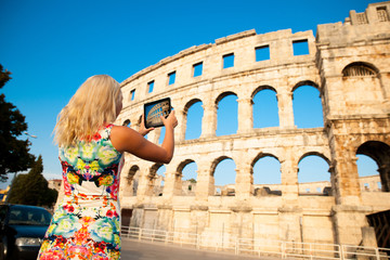 beautiful young woman turist taking photos of roman arena in Pula croatia