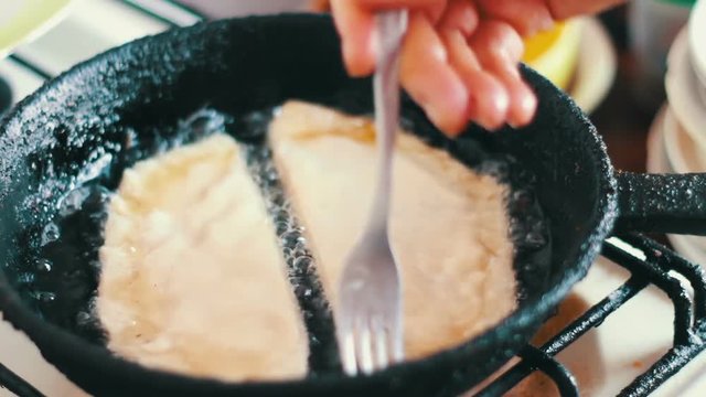 Housewife roasts chebureks in pan - Georgian national dish