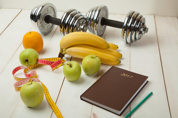 diet plan, menu or program, weight loss, measuring tape, dumbbells and dietary food fresh fruit