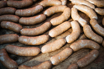 fresh homemade sausages on the wooden table