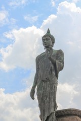 Big Buddha statue ancient on blue sky and raincloud background  in Nakhon Pathom Province of Thailand