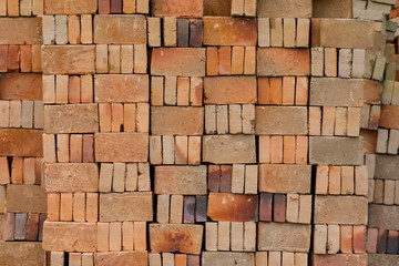 Basic red house bricks stacked in a pattern viewed straight on.