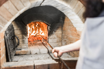 Close-up of the coals, and poker in a Russian oven