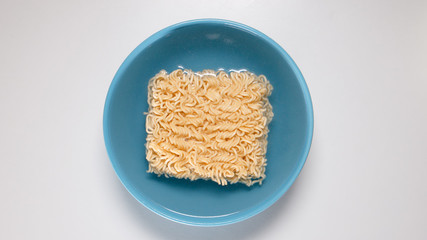 TOP VIEW: Quick noodles in blue bowl