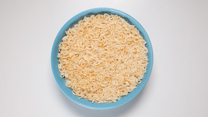 TOP VIEW: Prepared quick noodles in blue bowl