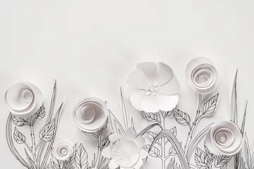 3d paper flowers with painted leaves and stems on the white background