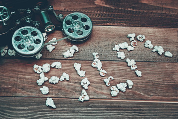 Fototapeta premium vintage music box in the shape of an old movie camera and popcorn. retro tones. copy space
