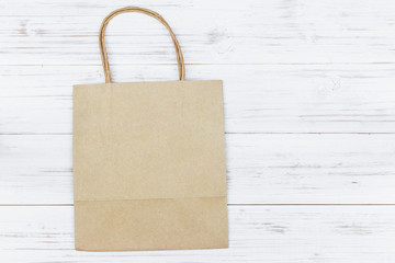 Paper bag on wooden background