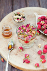 Herbal tea with rose buds and fresh raspberry.