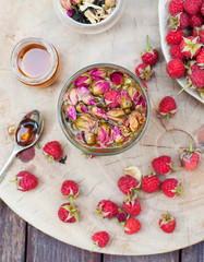 Herbal tea with rose buds and raspberry. Top view.