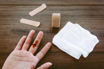 Fototapeta na wymiar Injured finger on wooden table
