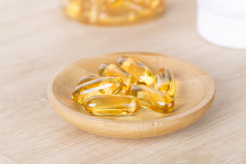 Healthy life style, Fish oil capsules and salad on the table