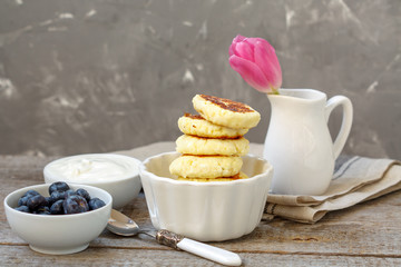 Cottage cheese pancakes for breakfast with blueberries and sour cream.