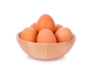 Eggs in wooden bowl isolated on white background