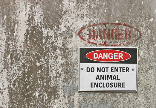red, black and white Danger, Do Not Enter Animal Enclosure warning sign