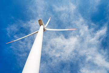 Wind turbines  against a blue sky generating electricity