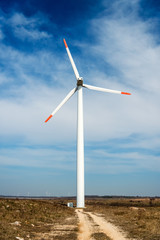 Fototapeta premium Wind turbines against a blue sky generating electricity