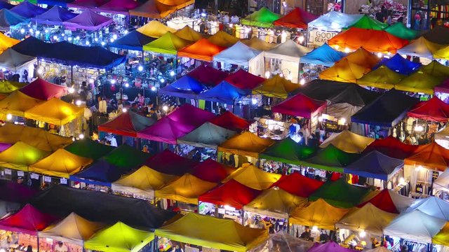 High view of colorful tent retail shop with night light at Talad Rod Fai Night Market, Ratchada, Bangkok, Thailand, 4k
