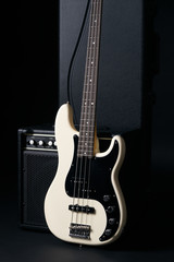 Obraz na płótnie Canvas Black and white electric bass guitar,hard case on black background .
