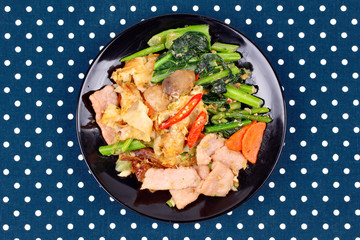 Fried big noodle topped mixed vegetables for organic food.