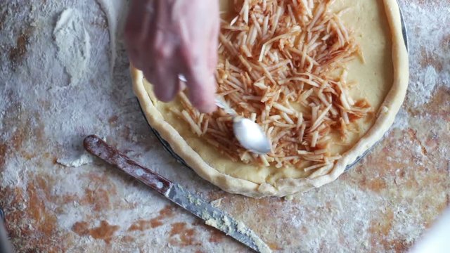 A woman is preparing an apple pie in a home kitchen,Fast shooting